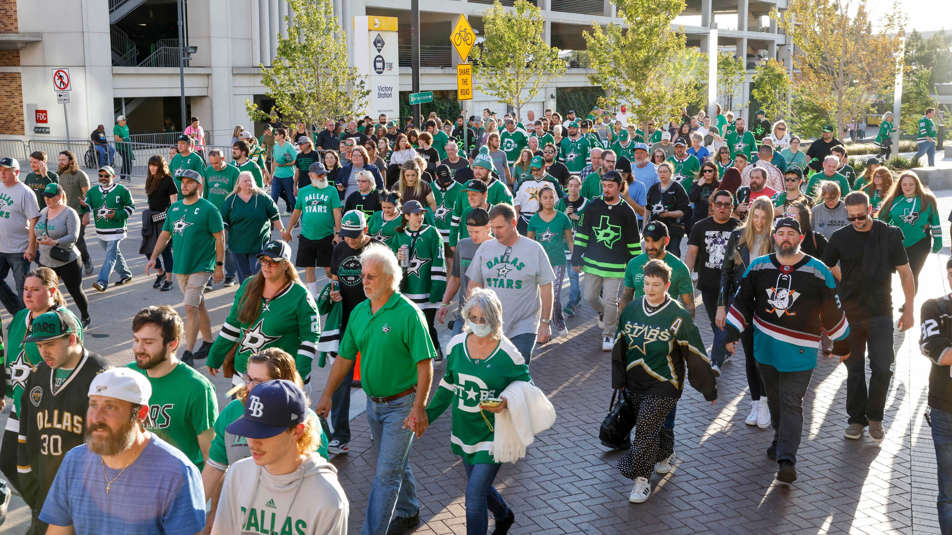 Hockey fans cross Victory Avenue before the start of the Stars home opener against the...