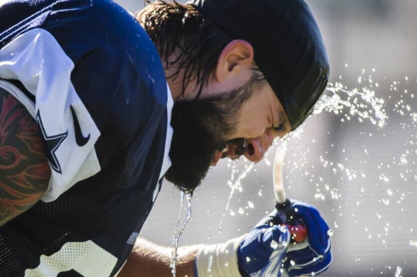 Dallas Cowboys defensive tackle Nick Hayden cools off during afternoon practice at training...