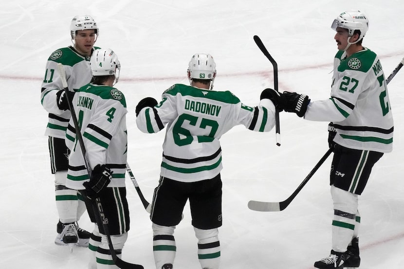 Dallas Stars right wing Evgenii Dadonov (63) celebrates with teammates after scoring against...