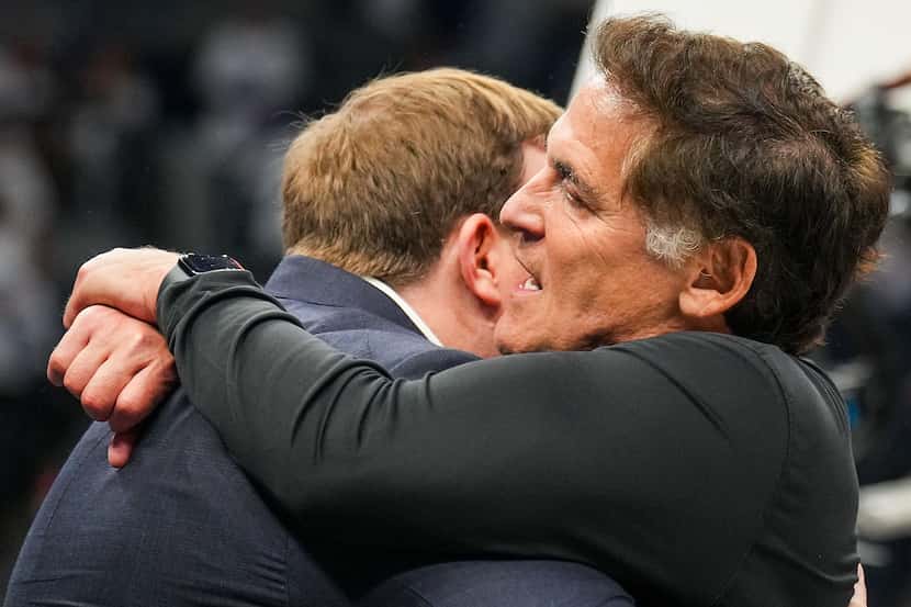 Dallas Mavericks minority owner Mark Cuban hugs governor Patrick Dumont in the final seconds...