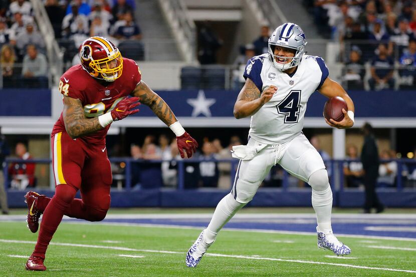 Dallas Cowboys quarterback Dak Prescott (4) escapes from Washington Redskins outside...