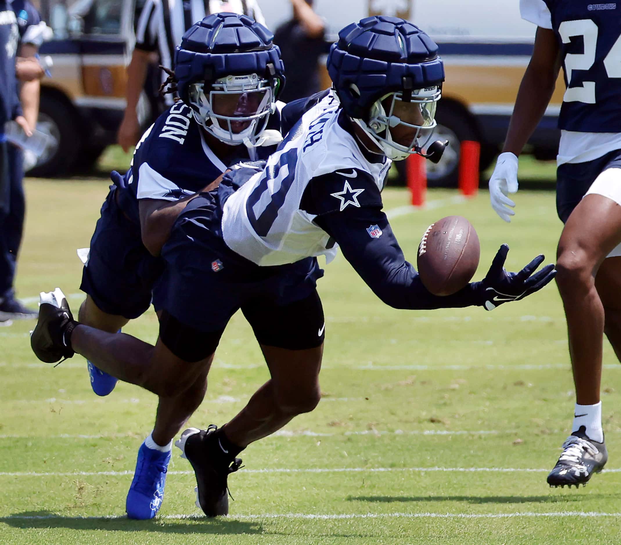 Dallas Cowboys wide receiver Racey McMath (80) tries to pull in a one-handed catch as he’s...