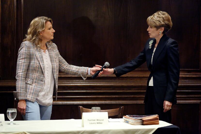Dallas City Council member Jennifer Staubach Gates (left) hands the microphone to former...