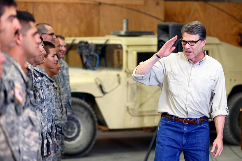 Gov. Rick Perry salutes National Guard troops at Camp Swift in Bastrop, Texas on Wednesday,...