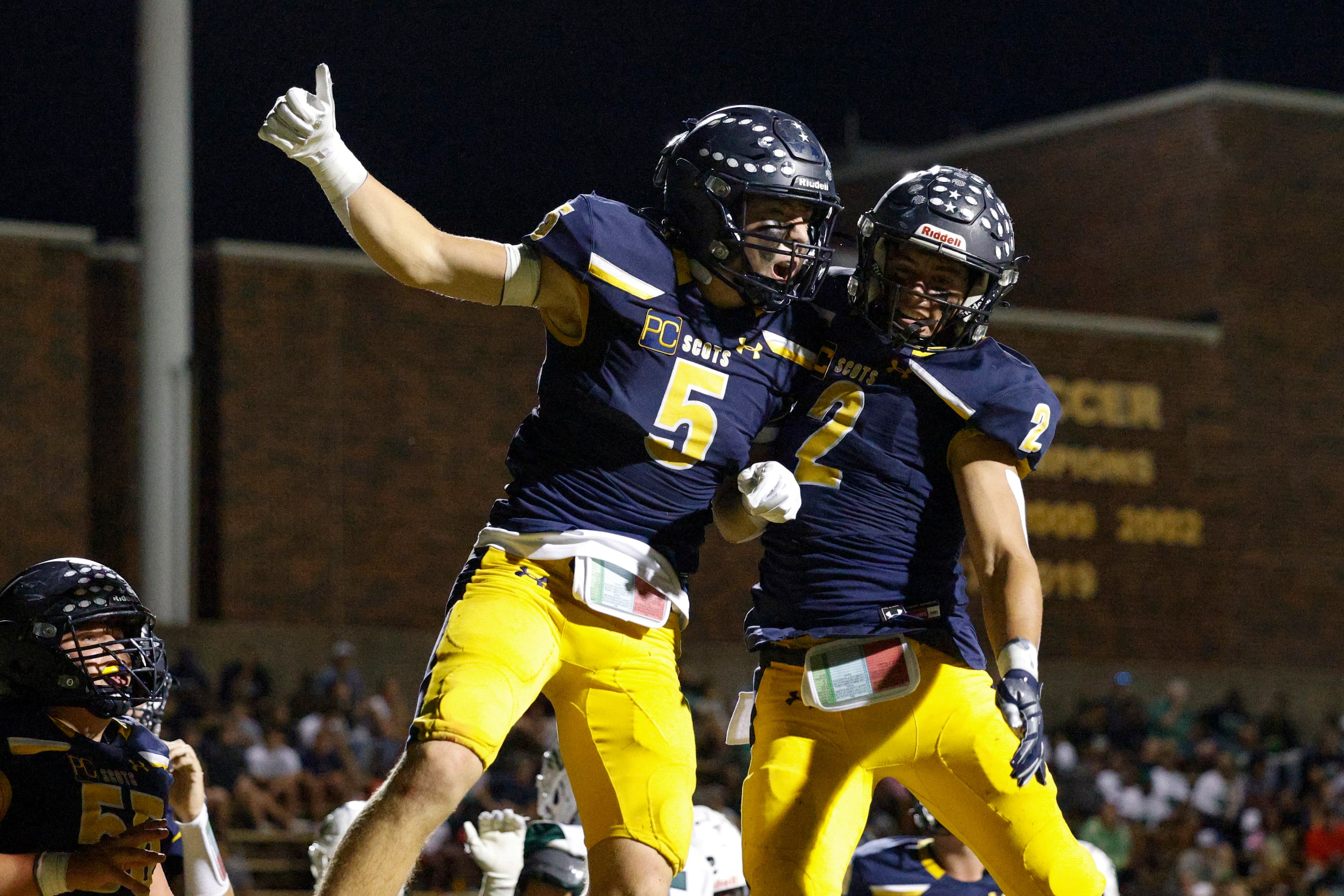 Highland Park running back Keller Holmes (5) celebrates his touchdown with running back...