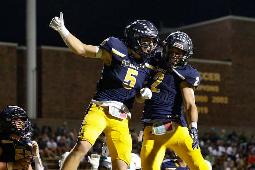 Highland Park running back Keller Holmes (5) celebrates his touchdown with running back...