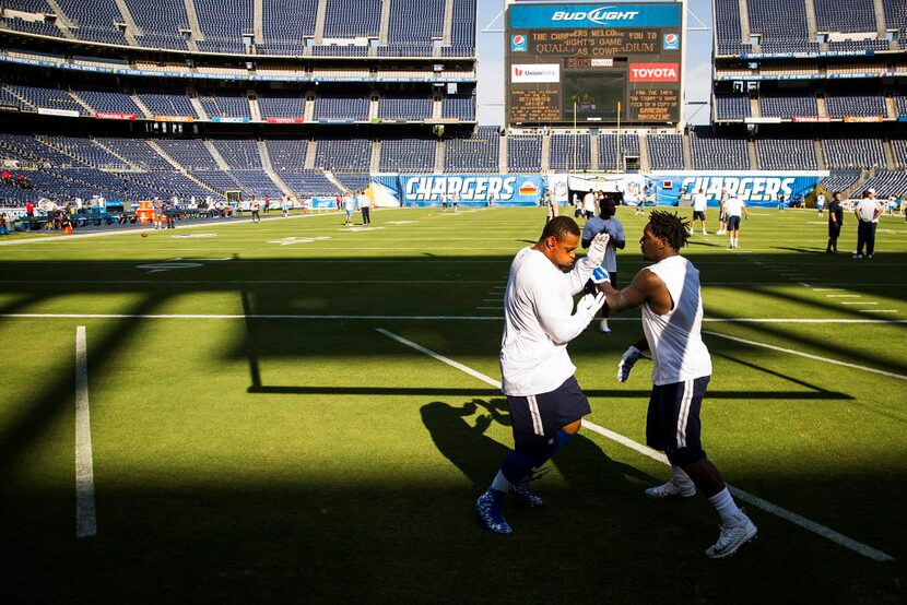 Dallas Cowboys defensive end Randy Gregory (right) and defensive end Greg Hardy warm up...