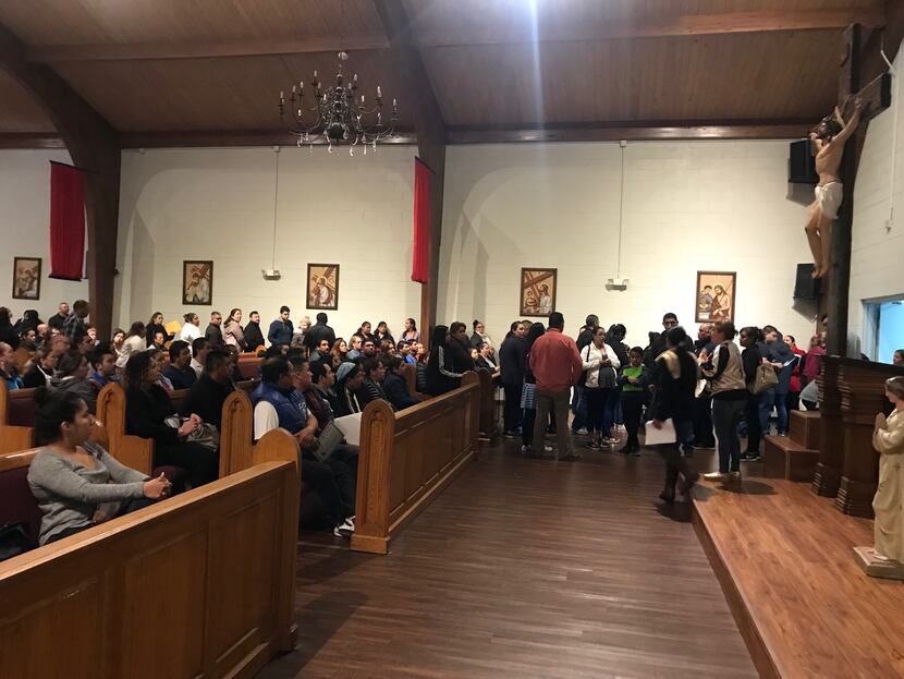 Hundreds of people wait their turn to apply for a church-issued identification cards at San...