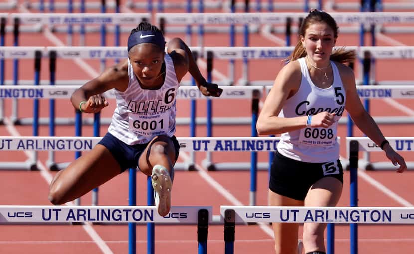 Allen’s Sidney Green (6) clears the last hurdle enroute to winning the 6A Girls 100 Meter...