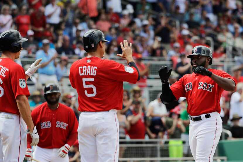 Boston Red Sox's Jackie Bradley Jr., right, is high-fived by Brian Bogusevic, left, and...
