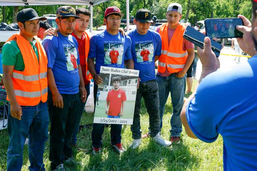 Family members and friends of Juan Ruben chel Botzoc wear shirts and hold a poster near...