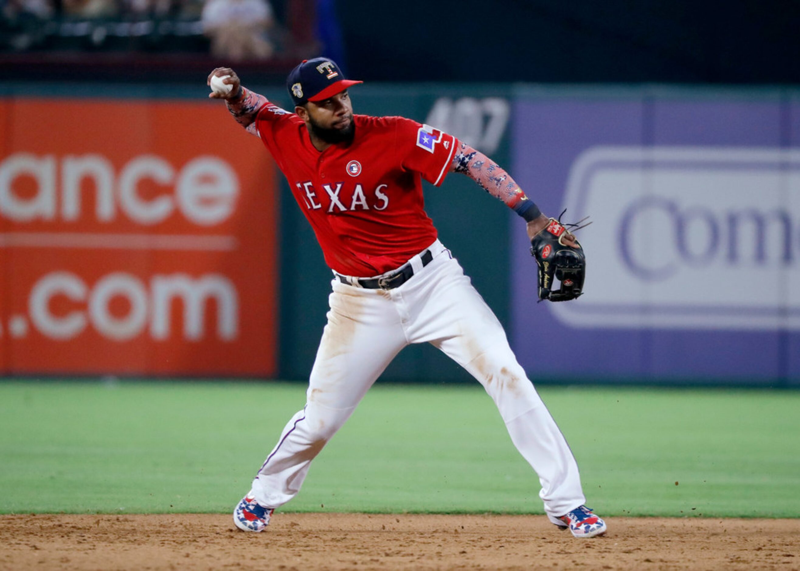 Texas Rangers shortstop Elvis Andrus throws to first after fielding a grounder by Los...