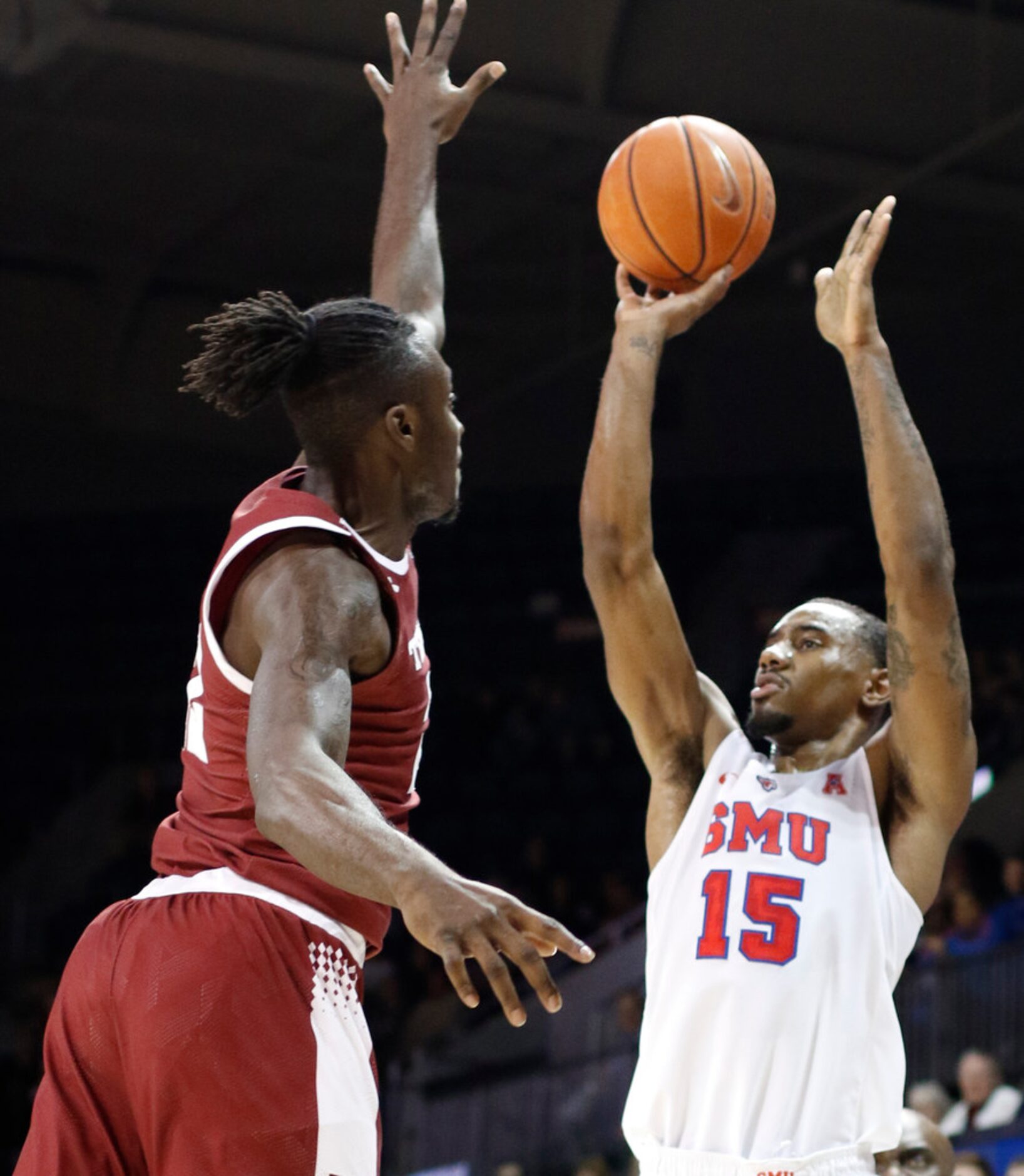 SMU forward Isiaha Mike (15) scores on a jump shot as he is defended by Temple forward...