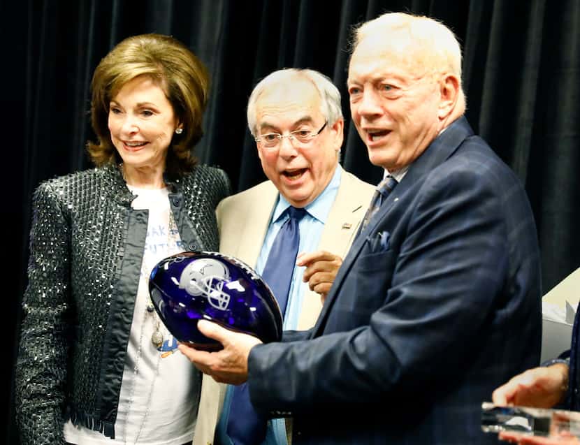 Cowboys owner Jerry Jones (right) and wife Gene honored team radio broadcaster Brad Sham by...