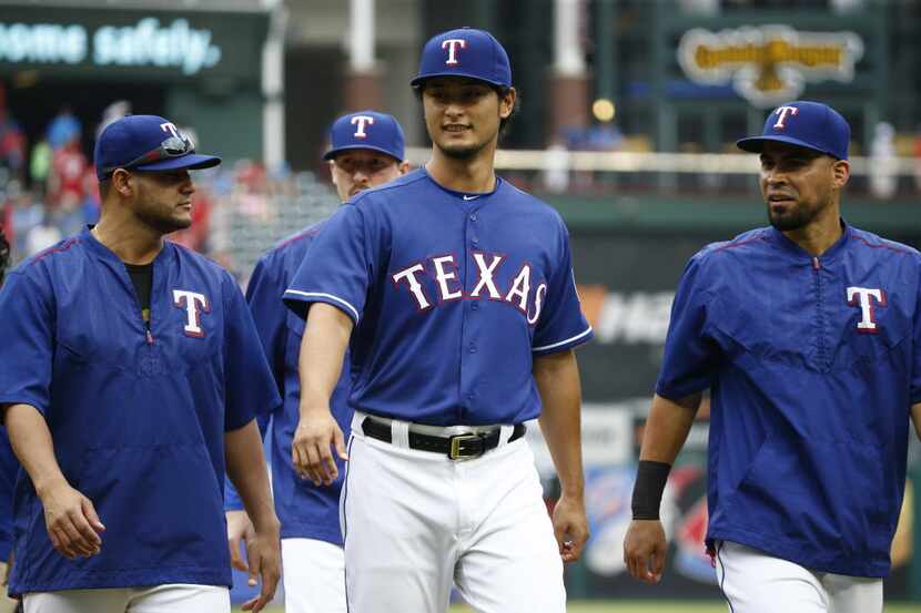 Texas Rangers starting pitcher Yu Darvish (11) walks off the field after they beat Los...