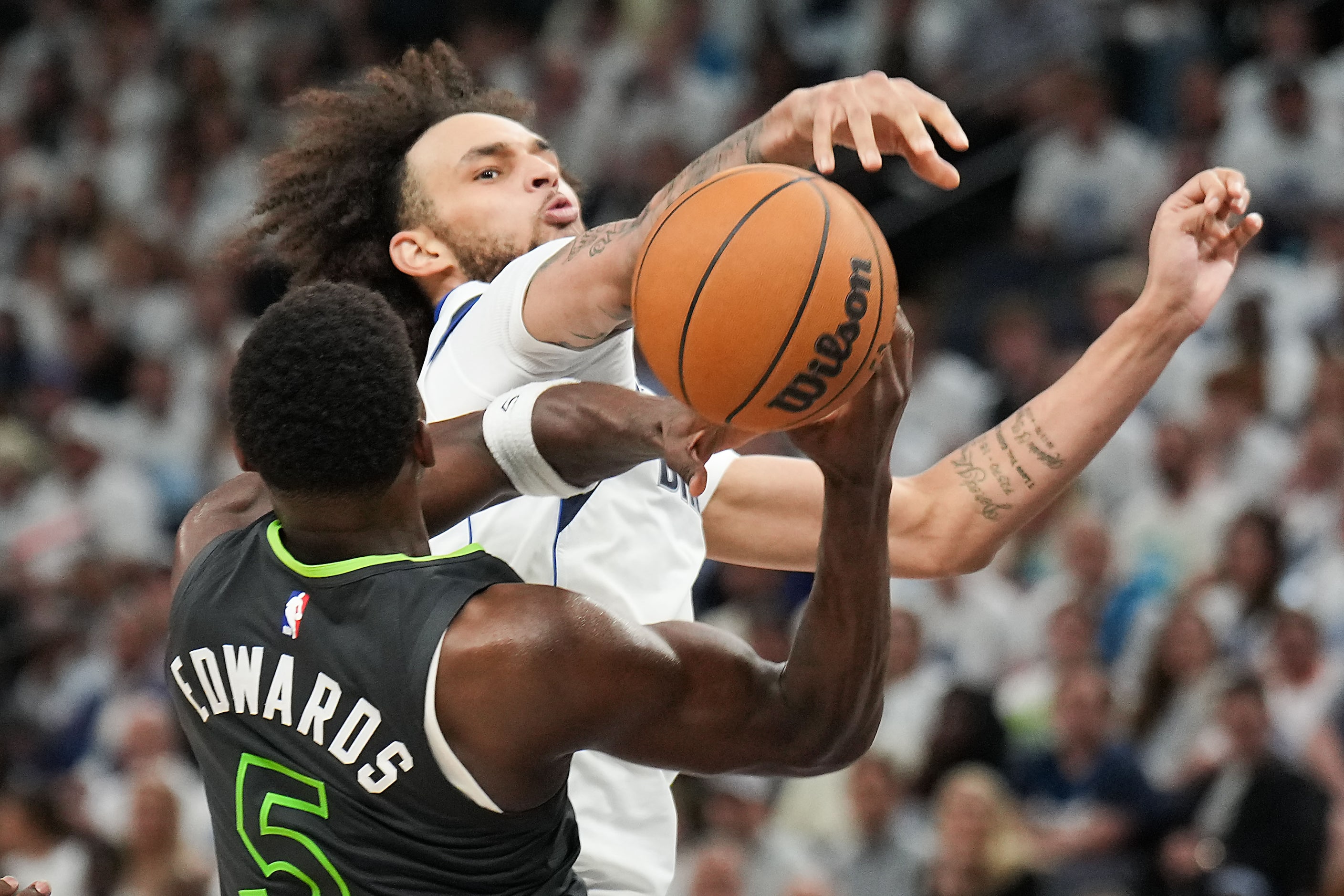 Dallas Mavericks center Dereck Lively II (2) knocks the ball away from Minnesota...