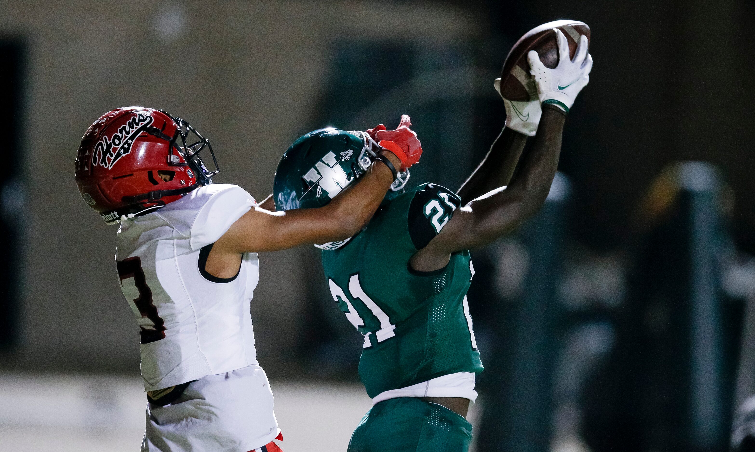 Waxahachie senior cornerback Xavien Thompson (21) intercepts a pass in the end zone intended...