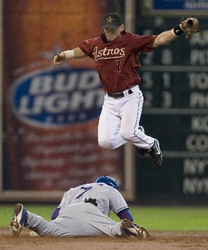 Texas Rangers' Kenny Lofton (7) slides under Houston Astros second baseman Craig Biggio for...