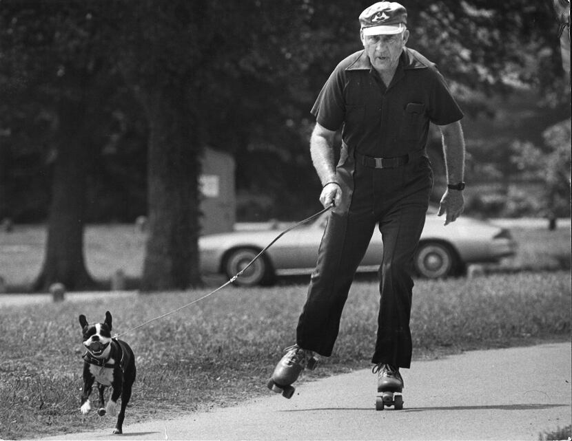 A man enjoying nature while rollerskating with his dog in 1981.
