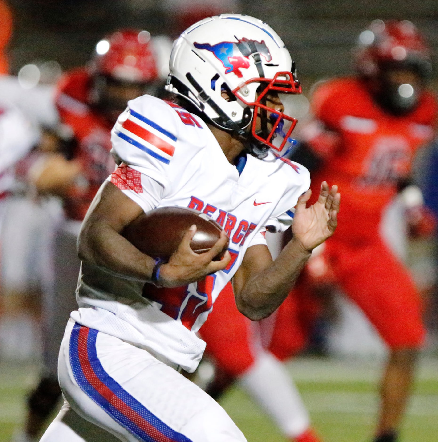 Pearce High School running back Dequan Landon (45) carries the ball during the first half as...