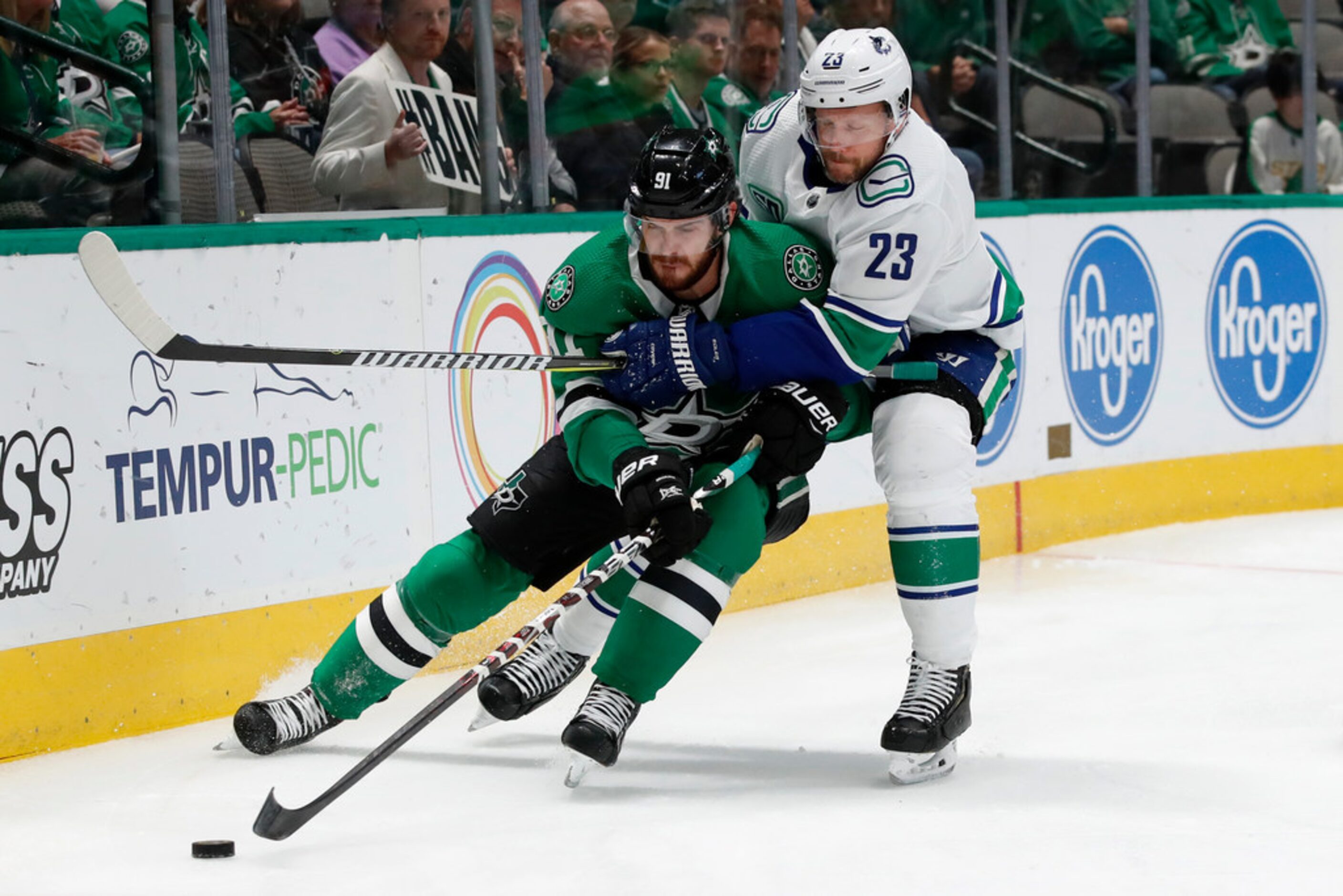 Dallas Stars center Tyler Seguin (91) and Vancouver Canucks defenseman Alexander Edler (23)...