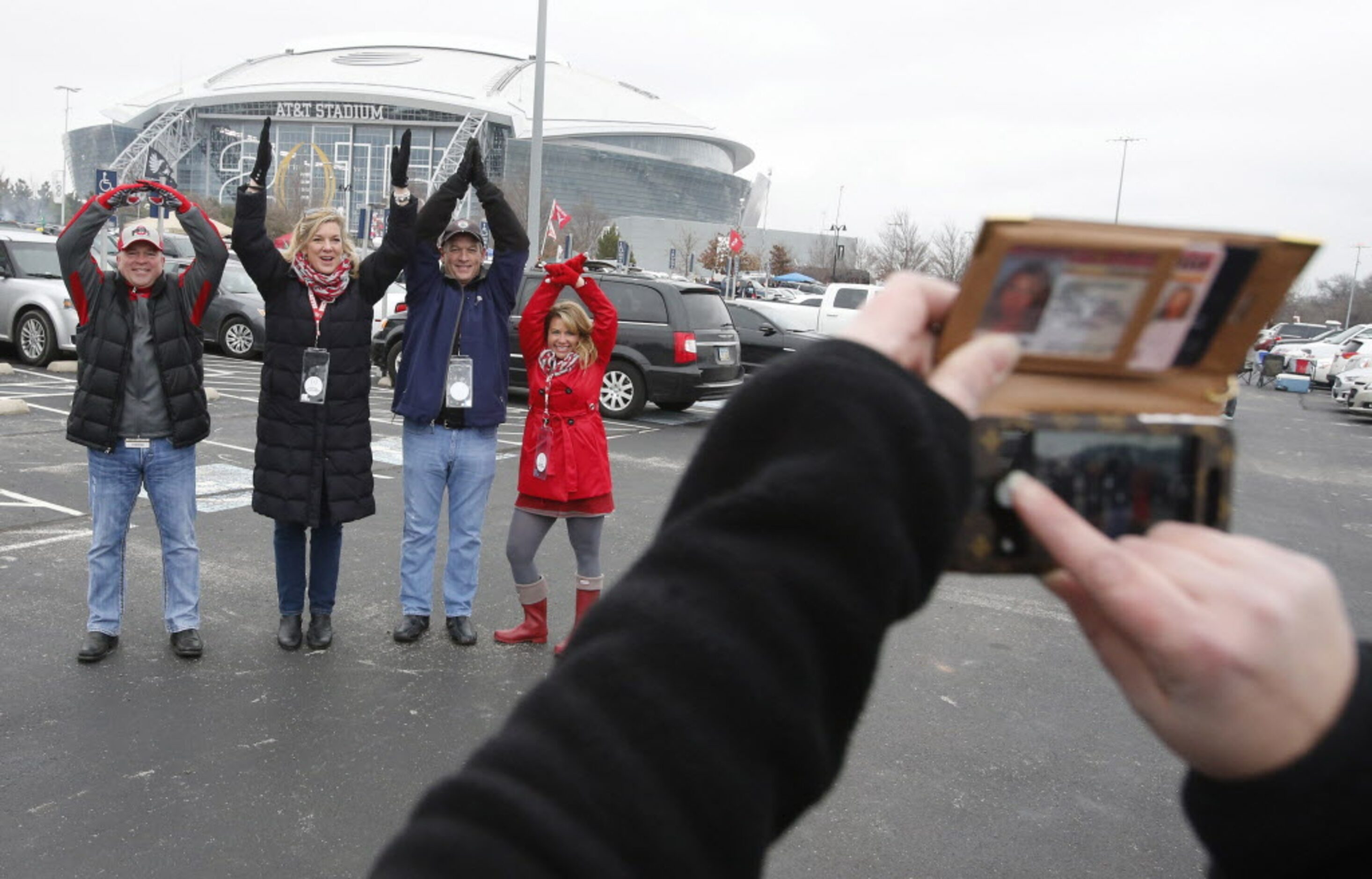 The Barnhart family from Columbus, Ohio, form the traditional 'Ohio' pose as they tailgate...