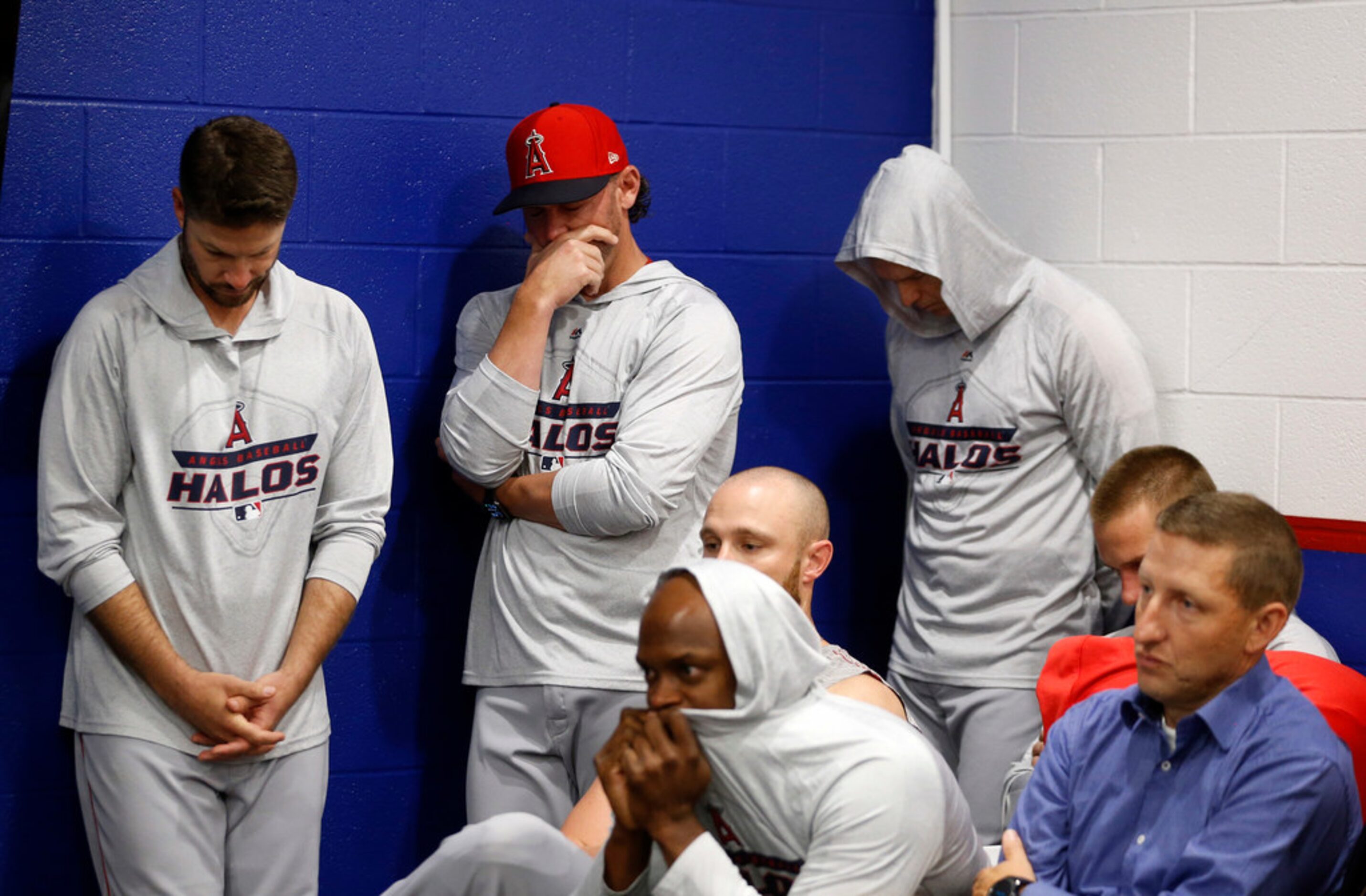 Los Angeles Angels players and staff sit and listen as Angels manager Brad Ausmus answers...