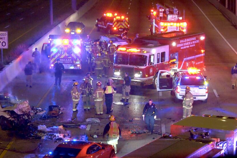 Dallas-Fire Rescue and Dallas Police personnel respond early Nov. 8, 2017 to a fatal crash...