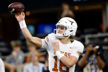 Texas Longhorns quarterback Arch Manning (16) warms up his arm during pregame workouts...