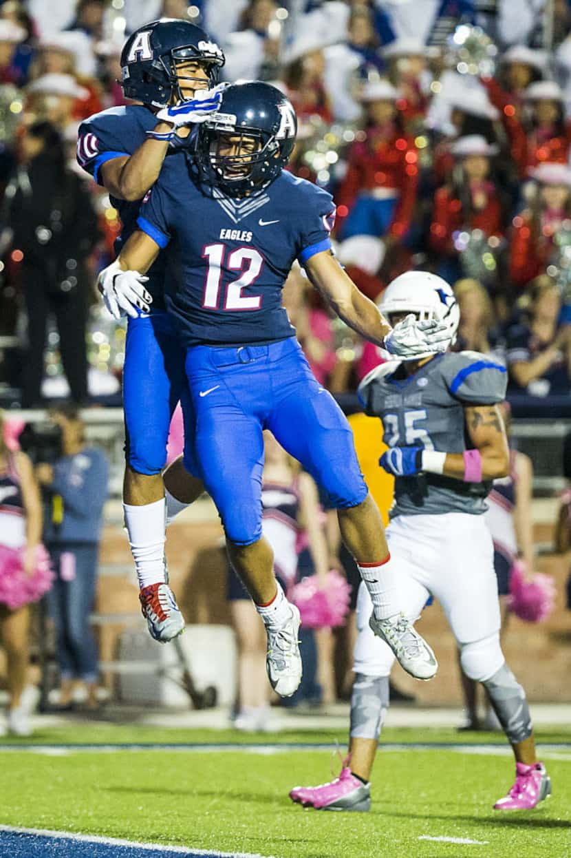 Allen wide receiver Jared Tajalle (10) celebrates with Carson Schleker (12) after catching a...