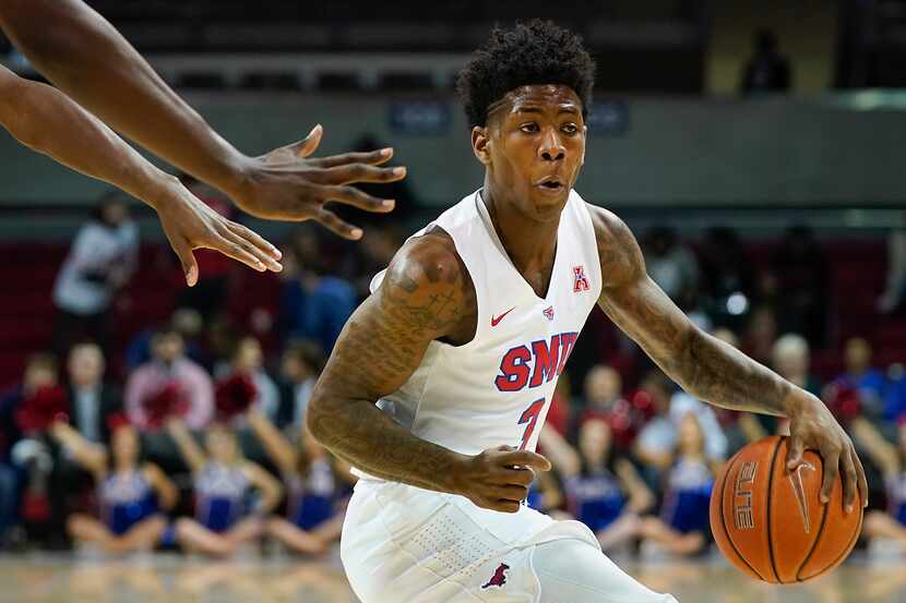 FILE - SMU guard Kendric Davis brings the ball up the floor during the first half of a game...