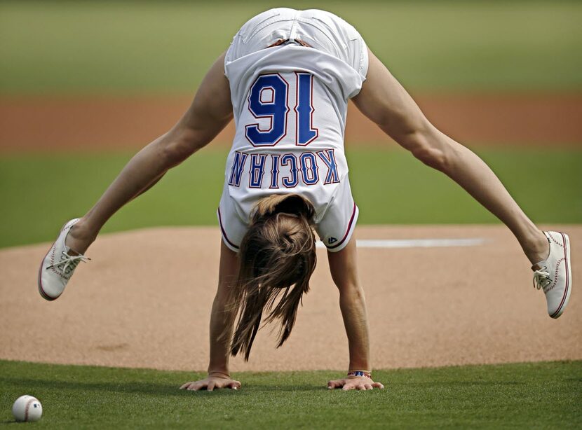 Olympic gold medalist Madison Kocian does a handstand as she prepares to throw out the first...