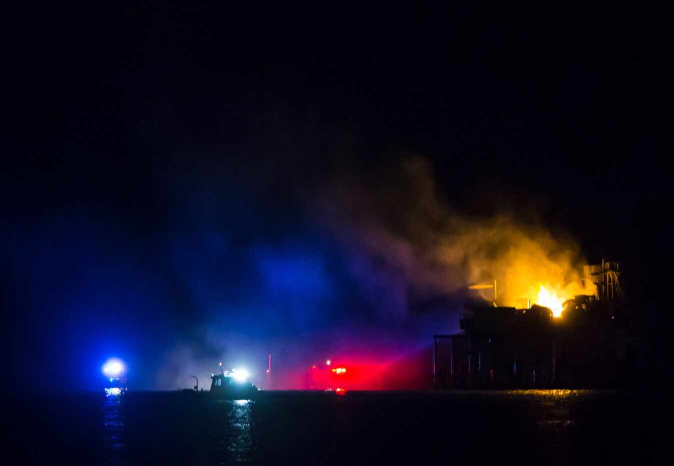 Rescue boats surround a rig in Lake Pontchartrain near New Orleans, La., after the rig...