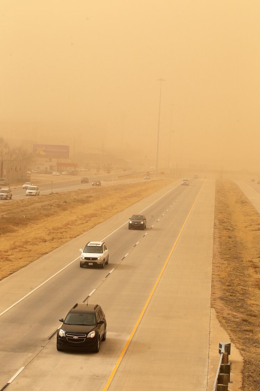 Cars navigate along the Marsha Sharp Freeway during a dust storm in Lubbock, Texas,...