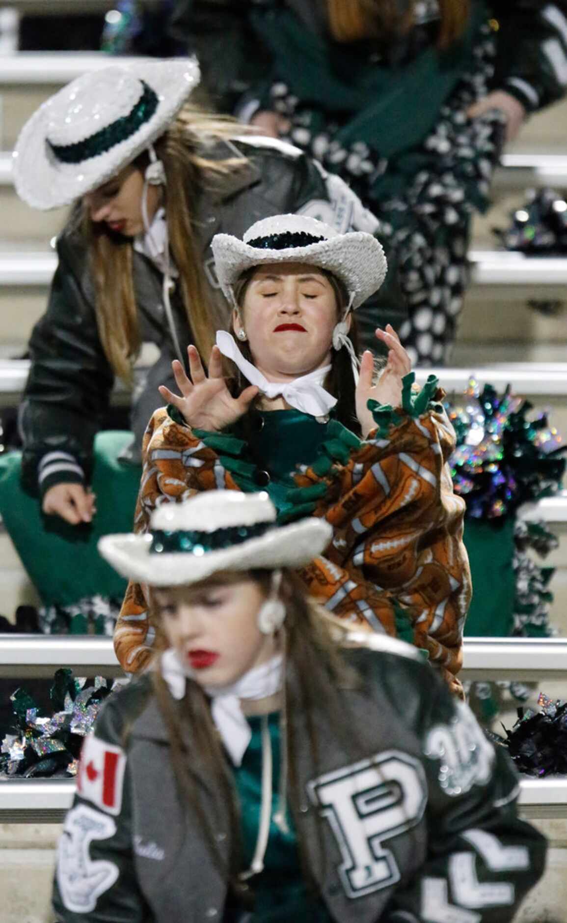 Rowan Abrams, 15, with the Prosper High School Talonette drill team, feels the bite of cold...