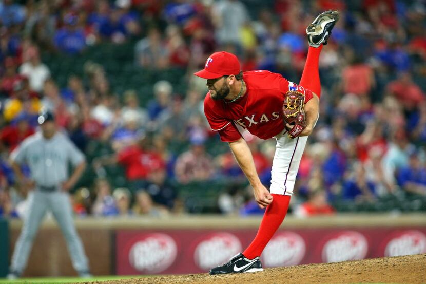 ARLINGTON, TX - JUNE 04: Tom Wilhelmsen #54 of the Texas Rangers throws in the ninth inning...