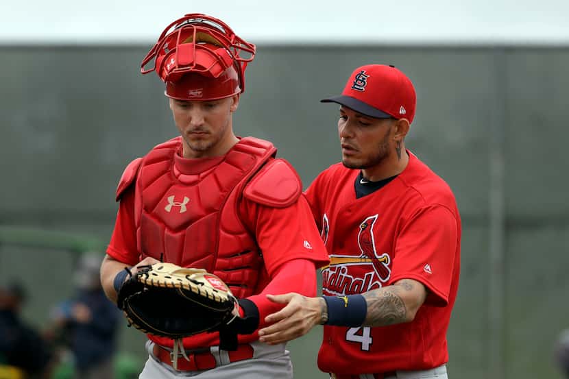 St. Louis Cardinals catcher Yadier Molina, right, works with fellow catcher Andrew Knizner...
