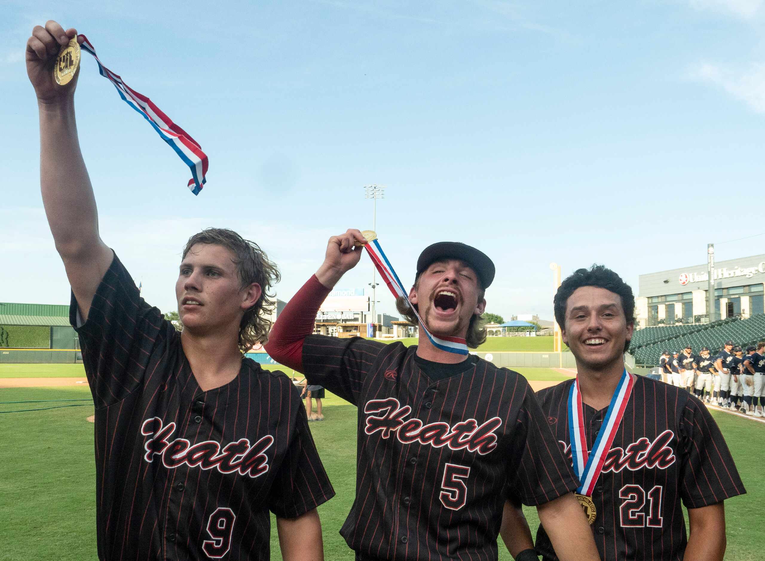 Rockwall-Heath Kevin Bazzell, (9), Karson Krowka, (5), and Zach Rike, (21),  celebrate with...