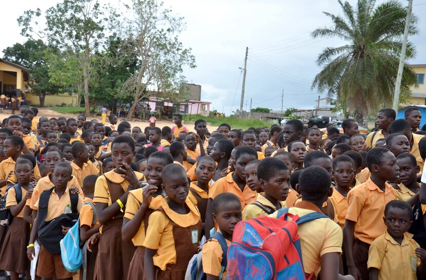 Kids line up in a schoolyard, one classroom at a time, to be seen at a dental clinic in...