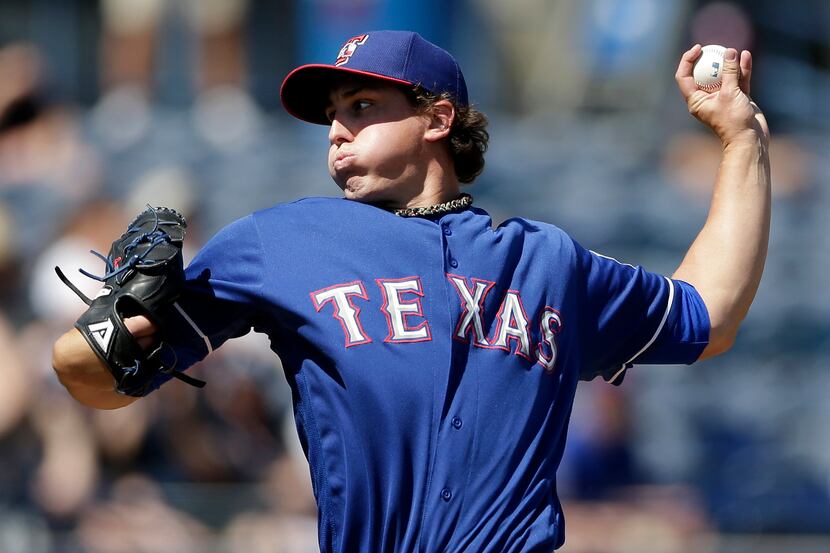 Texas Rangers starting pitcher Derek Holland throws against the San Diego Padres during the...