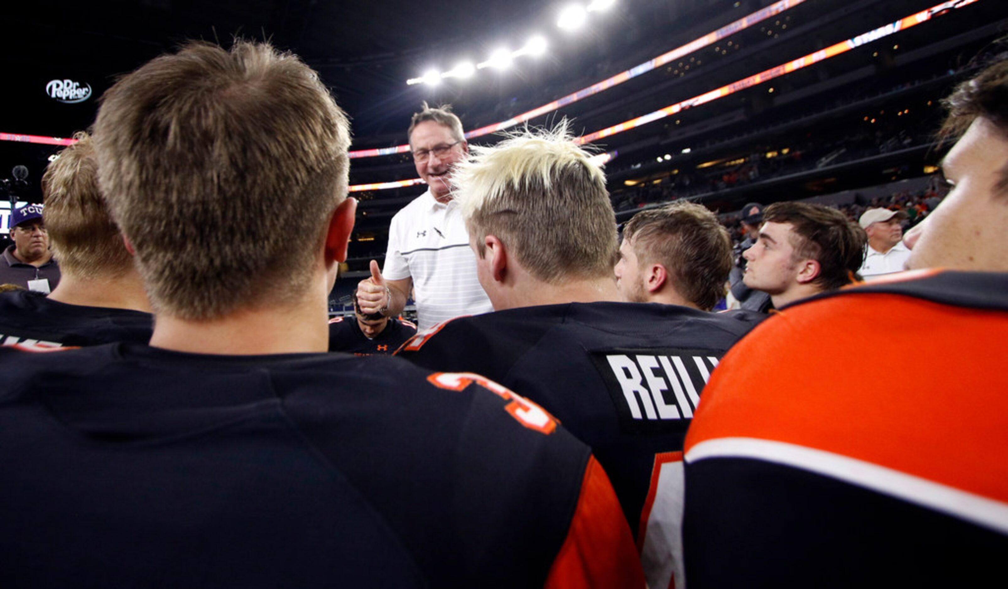 Aledo head coach Tim Buchanan gives thumbs up with his praise report for the Bearcats...