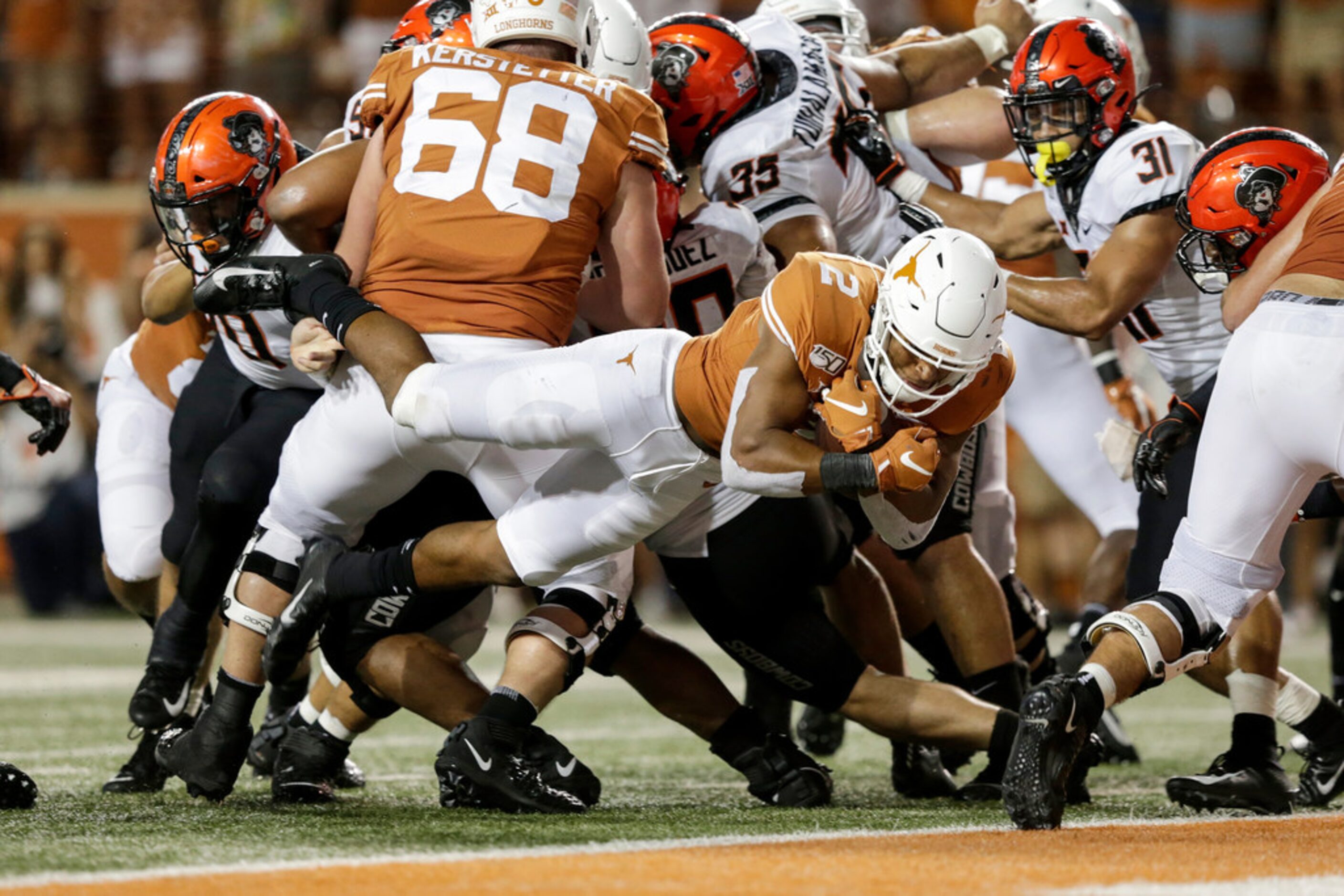 AUSTIN, TX - SEPTEMBER 21:  Roschon Johnson #2 of the Texas Longhorns dives for a touchdown...