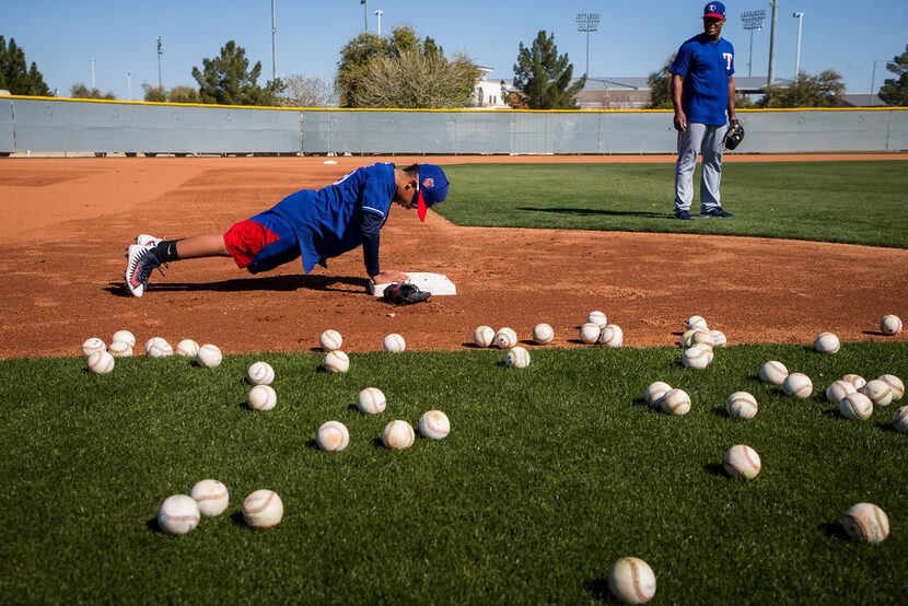 Adrian (A.J.) Beltre, Jr. does pushups, the result of a fielding error, while taking...