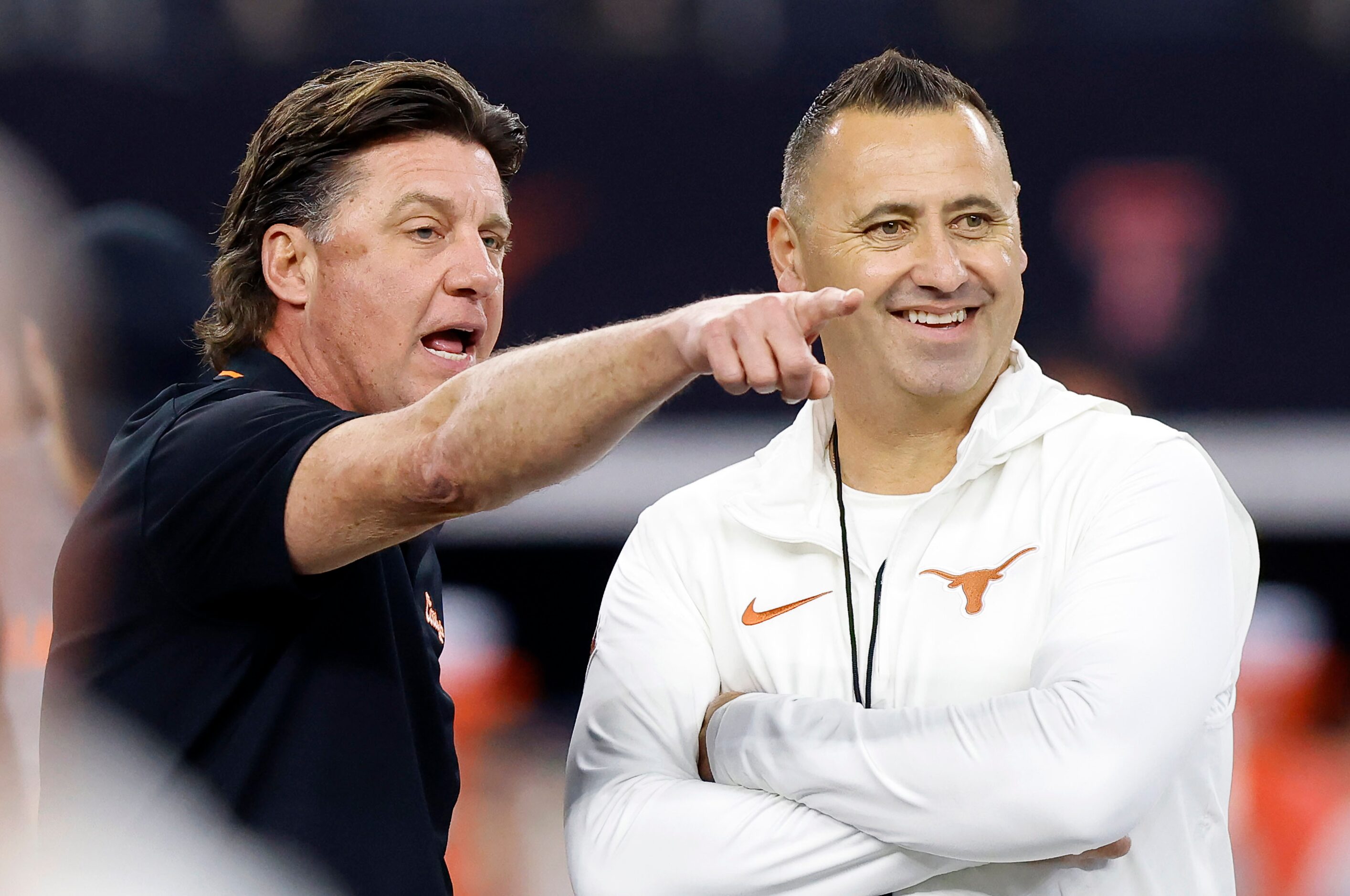 Oklahoma State Cowboys head coach Mike Gundy (left) and Texas Longhorns head coach Steve...