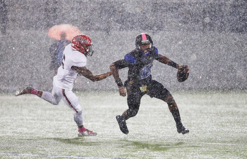 Mansfield Summit senior quarterback Brysen McKinney scrambles away from Cedar Hill senior...