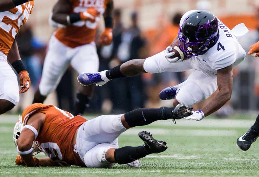 TCU Horned Frogs wide receiver Taye Barber (4) is tripped up by Texas Longhorns defensive...