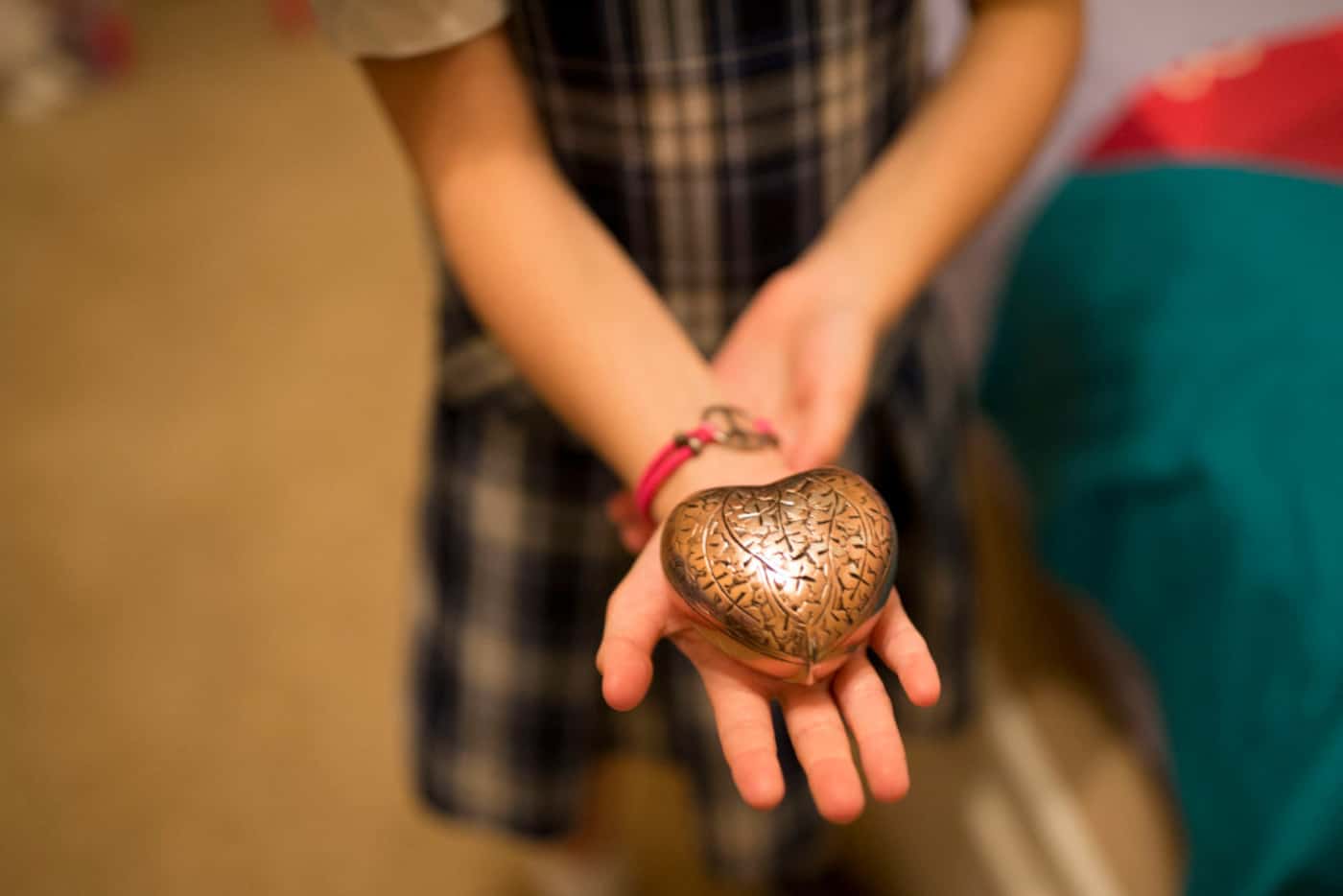 Lily Howard, 8, holds an urn containing some of her sister Harper's ashes. (Ting Shen/Staff...