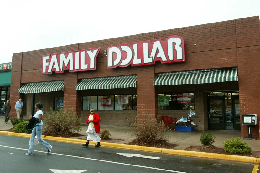 FILE - In this Tuesday, Nov. 29, 2005, file photo, customers walk past a Family Dollar store...