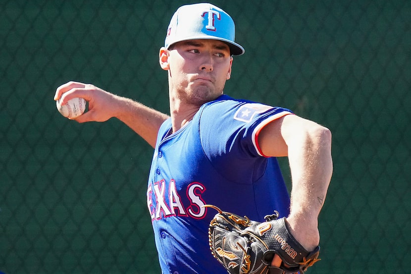 Texas Rangers pitcher Cole Winn throws in the bullpen during a spring training workout at...