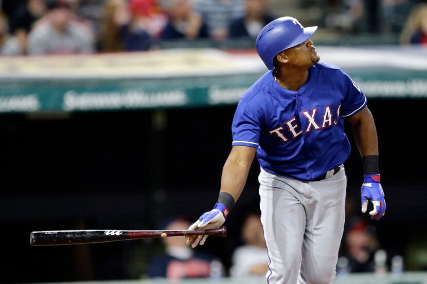 Texas Rangers' Adrian Beltre watches the ball after hitting a solo home run off Cleveland...